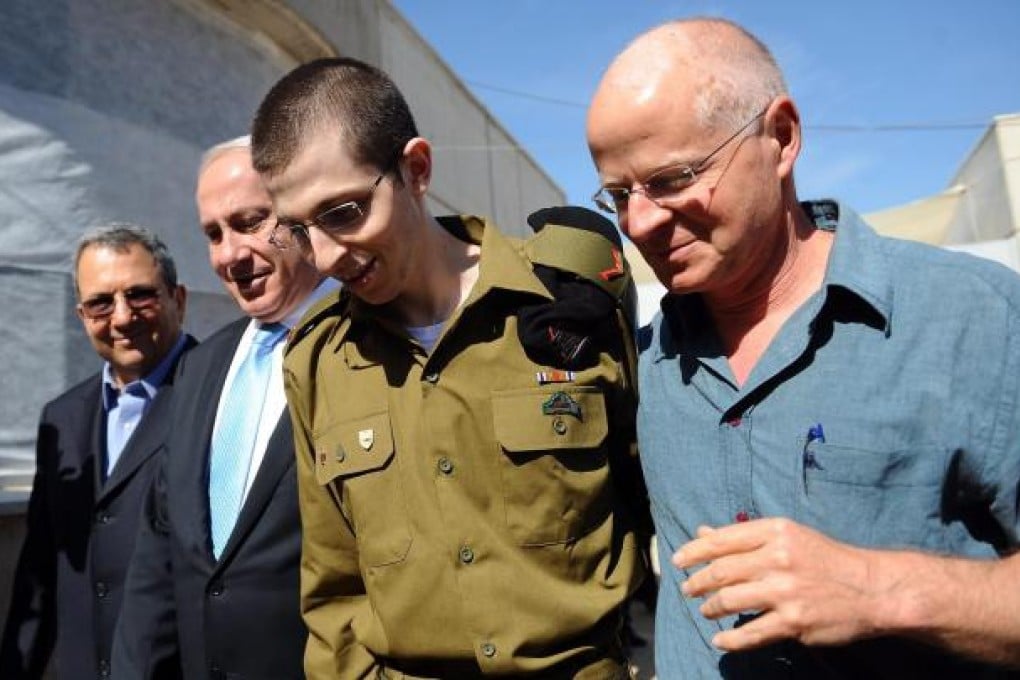 Gilad Shalit with father Noam (right) on his release a year ago. Photo: EPA