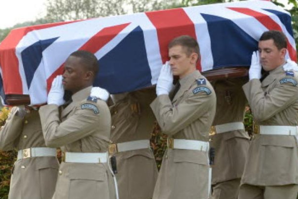 British Royal Air Force officers carry a coffin containing the remains of eight World War II crew members during a reburial ceremony in Kuala Lumpur on Thursday. Photo: AFP