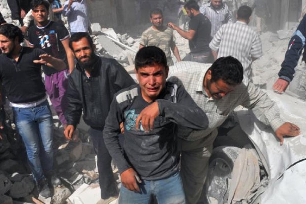 Syrian men react following an airstrike by Syrian government forces in Maaret al-Numaan on Thursday. Photo: AFP