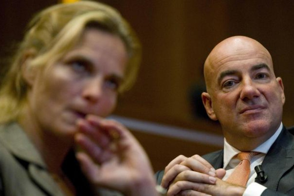 Heleen Crielaard, Rabobank head of sponsoring, and Harold Knebel, director of the cycling team, listen to announcement. Photo: Reuters
