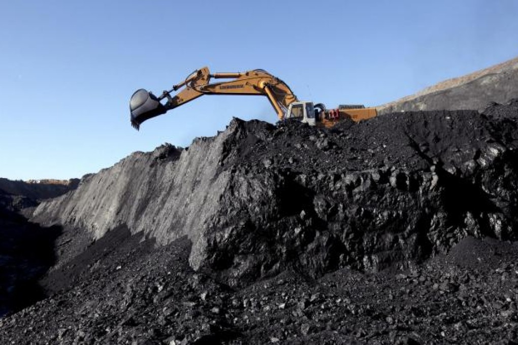 Heavy machinery moves coal at a SouthGobi mine. A Chinese state company dropped plans to buy the miner. Photo: Bloomberg