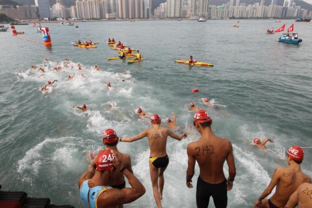 Swimmers plunge into Victoria Harbour for the New World Harbour Race. Photo: SCMP