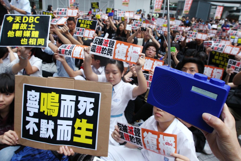 Supporters of the Digital Broadcasting Corporation's protest yesterday with signs outside the government headquarters at Admiralty. Photo: Felix Wong
