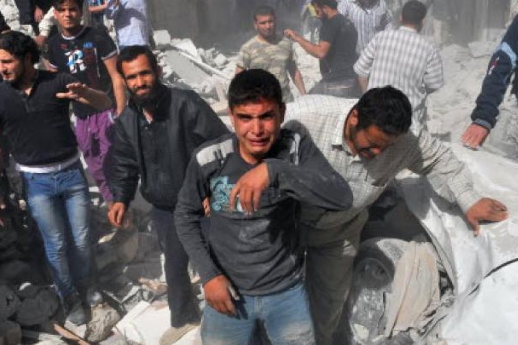 Syrian men react following an airstrike by Syrian government forces in Maaret al-Numaan on Thursday. Photo: AFP