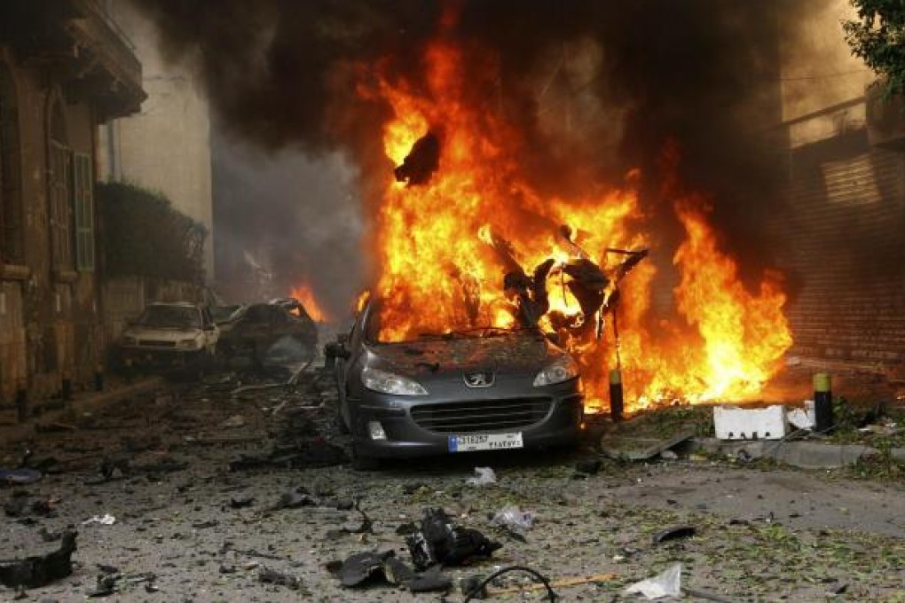 A car burns after an explosion in east Beirut. The blast damaged cars and destroyed the front of a multi-storey building. Photo: Reuters