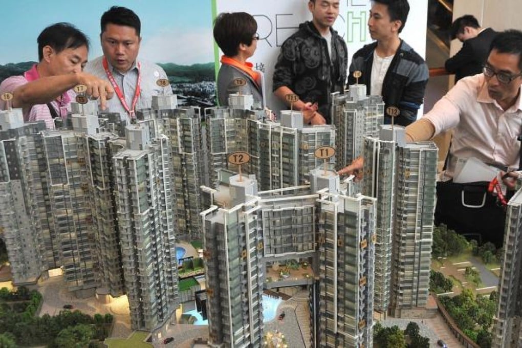 Potential buyers view a model of the Reach. More than 70,000 people have visited the show flats of the project, one of many being rushed to the market. Photo: SCMP