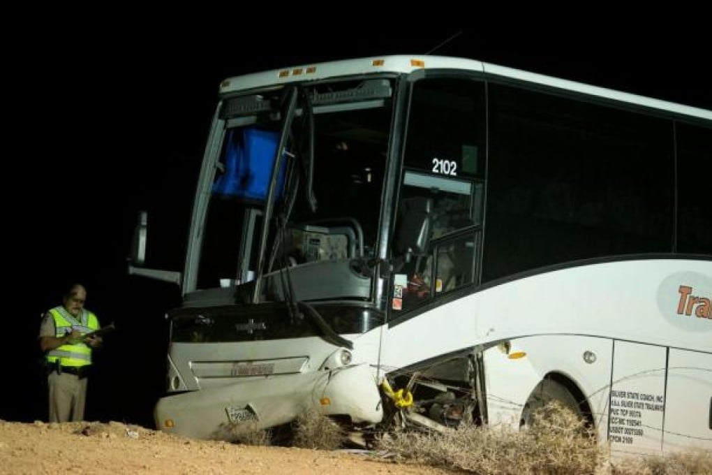 An Arizona Highway Patrol officer examines the tour bus that crashed on its way from the Grand Canyon to Las Vegas. Photo: AP