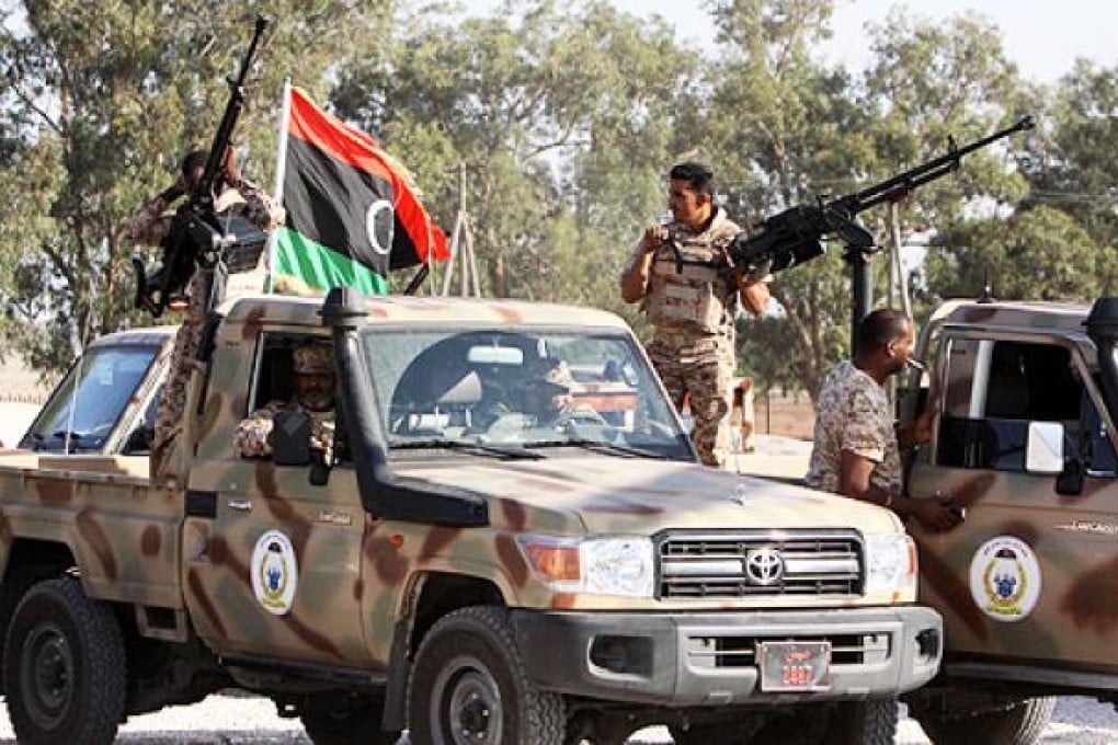 Libyan army forces gather at their headquarters in Tripoli before deploying to Bani Walid on Thursday. Photo: Xinhua