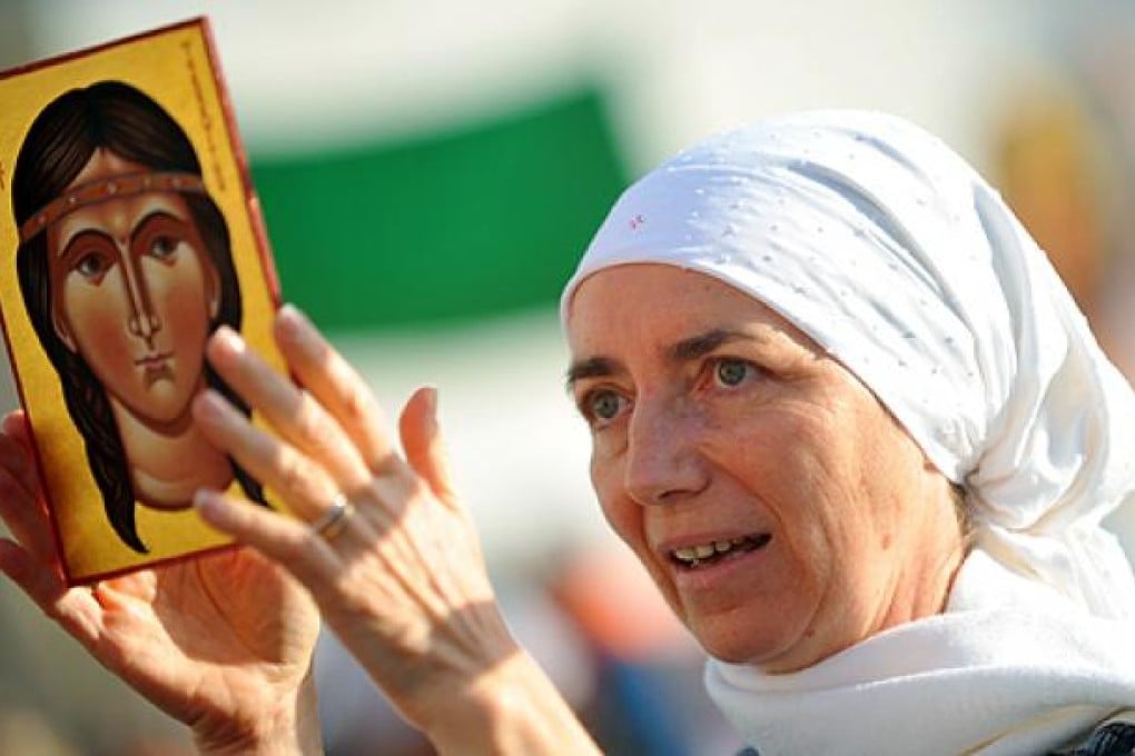 A faithful attends a special mass to name seven new saints, including Kateri Tekakwitha who has been a symbol of hope for American Indians for centuries. Photo: AFP