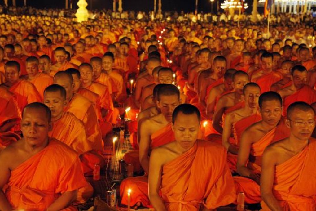 Cambodian Buddhists pray for the soul of late King-Father Norodom Sihanouk in front of the Royal Palace in Phnom Penh, Cambodia.