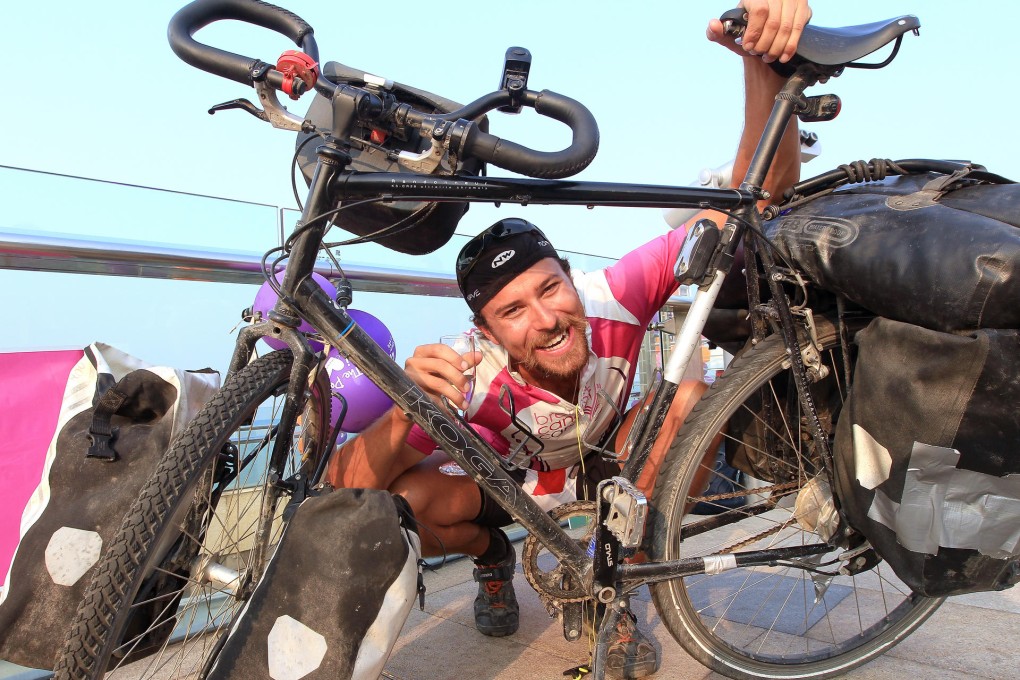 Mark Wright on The Peak Tower after cycling from London to raise money for Breast Cancer Care. He started his journey in April and rode through 19 countries.