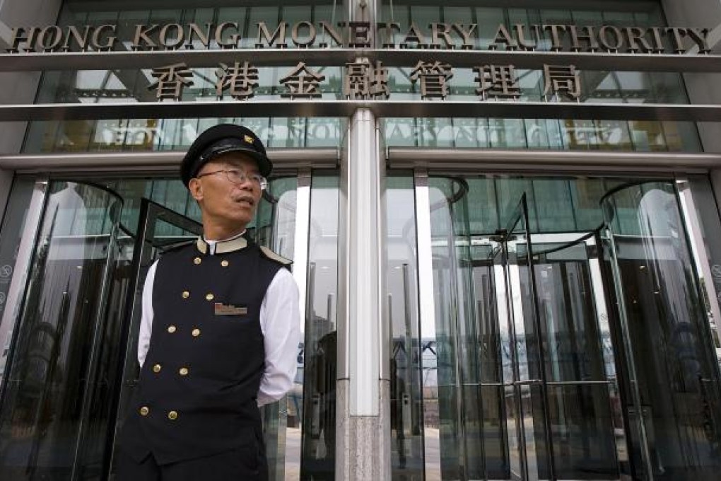 A security guard at the Hong Kong Monetary Authority headquarters. Some investors are betting the peg will go. Photo: Bloomberg
