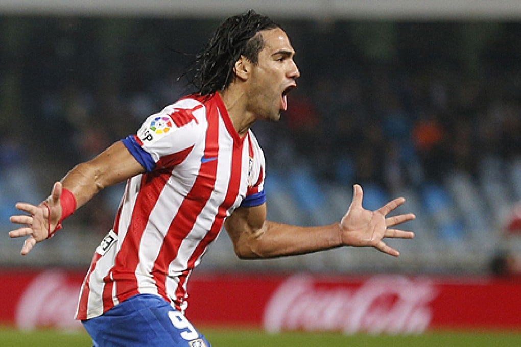 Atletico Madrid's forward Radamel Falcao scores against Real Sociedad on Sunday. Photo: AFP