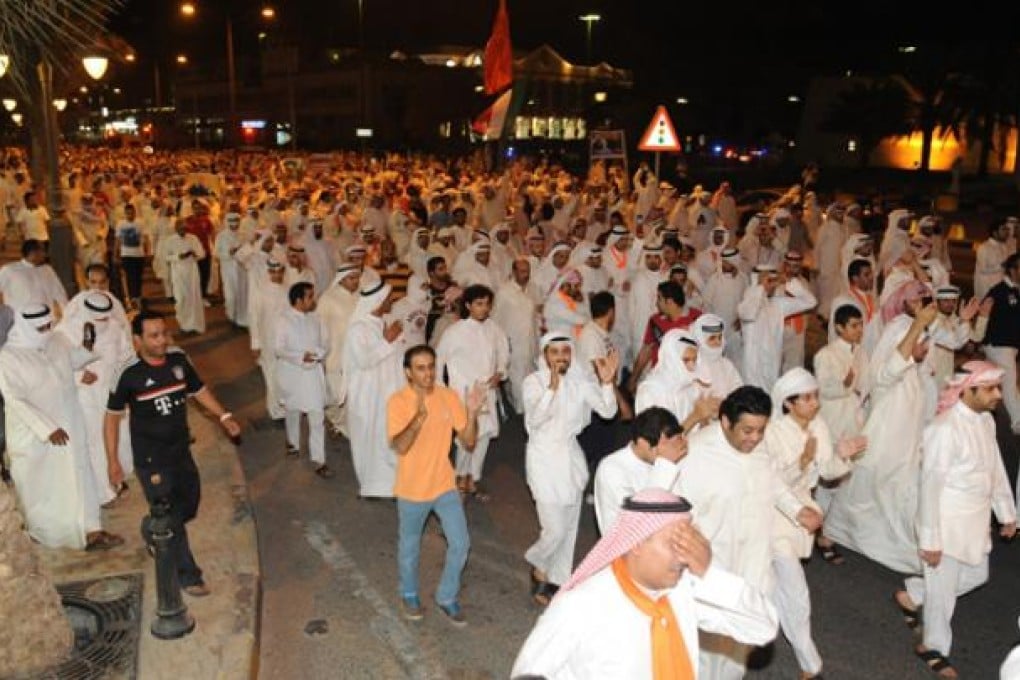Kuwaiti opposition supporters march during a demonstration in Kuwait on Sunday. Photo: EPA