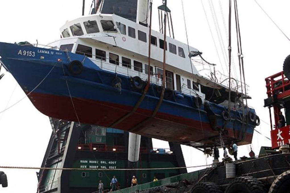 The Lamma IV is lowered onto a barge off Lamma Island on October 14. Photo: AFP