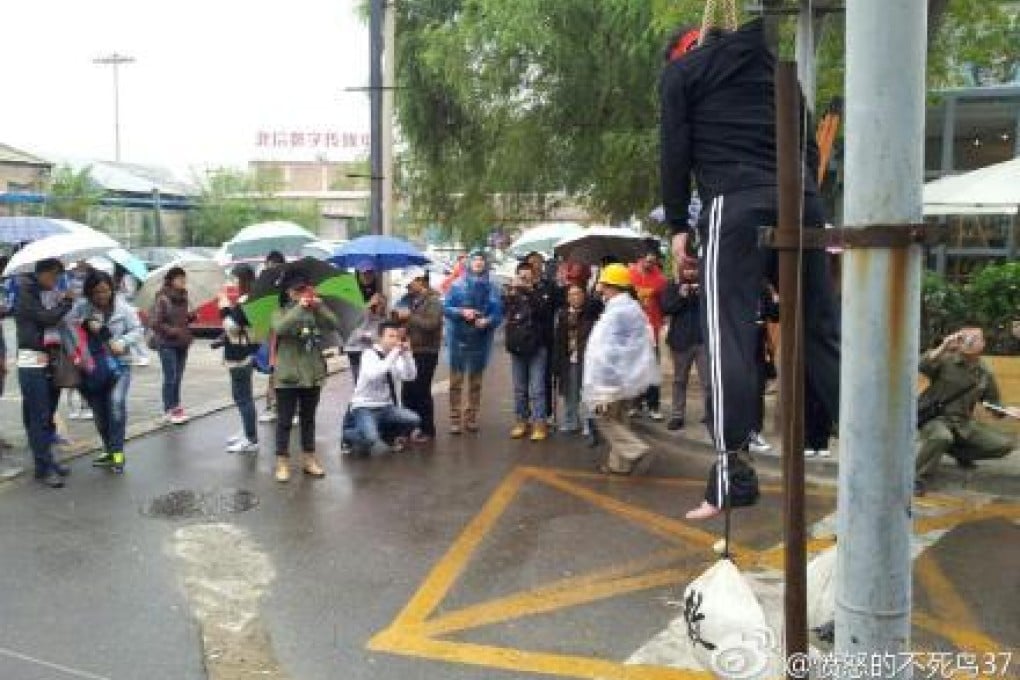 A netizen protests re-education through labour Sunday at Beijing's 798 art district.