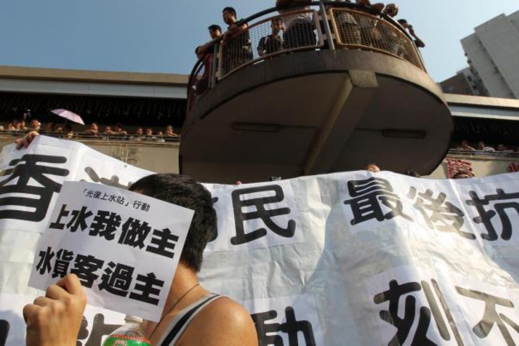 Supporters of the Reclaim Sheung Shui movement chant slogans against parallel goods traders. Photo: Nora Tam