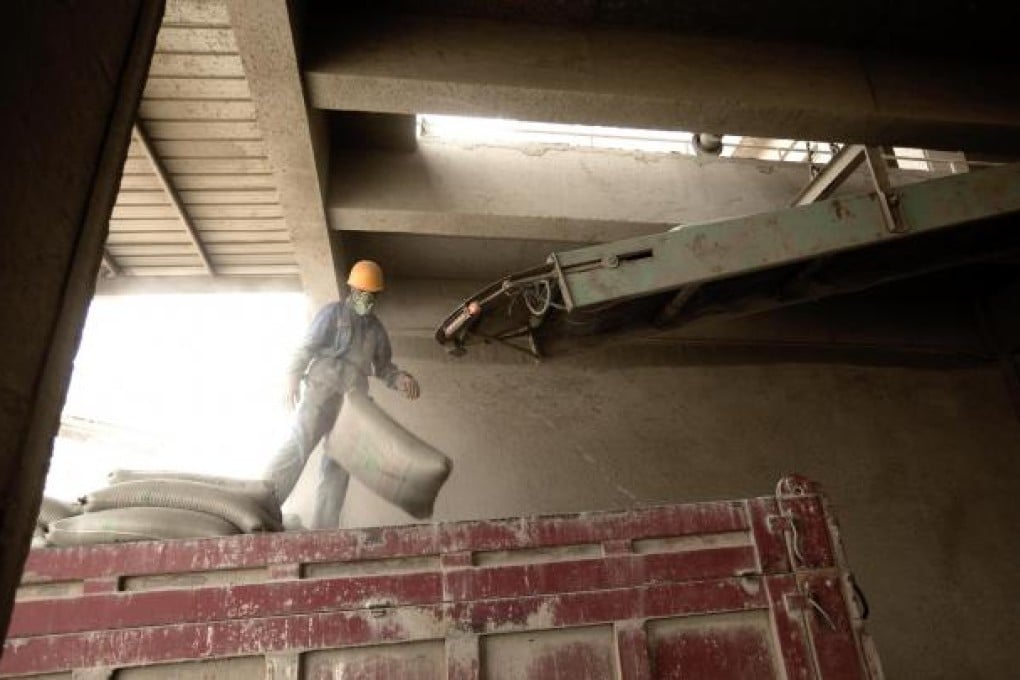 The stuff that binds: A worker loads cement on to a truck at a West China Cement plant. Photo: Bloomberg