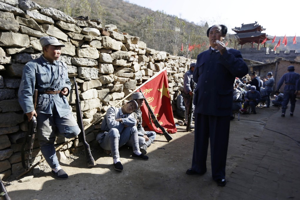 An actor (far right) plays Mao Zedong in a battle re-enactment at a tourist attraction in Yanan, Shaanxi, his base in the 1930s. Photo: AP