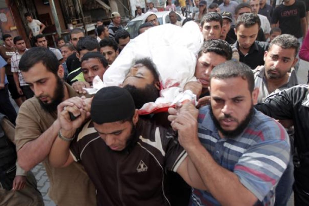 Palestinian mourners carry the body of militant Mohamed al-Shikh during his funeral in Rafah, on Wednesday. Photo: AFP