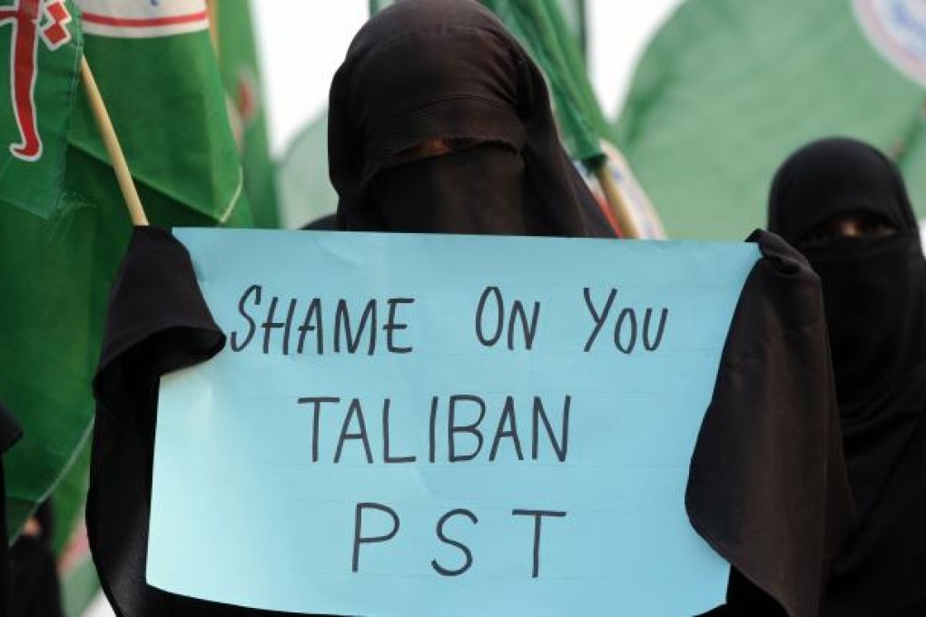 Veiled Pakistani activists of the Islamic Sunni Tehreek party protest against the assassination attempt on Malala Yousafzai by the Taliban. Photo: AFP