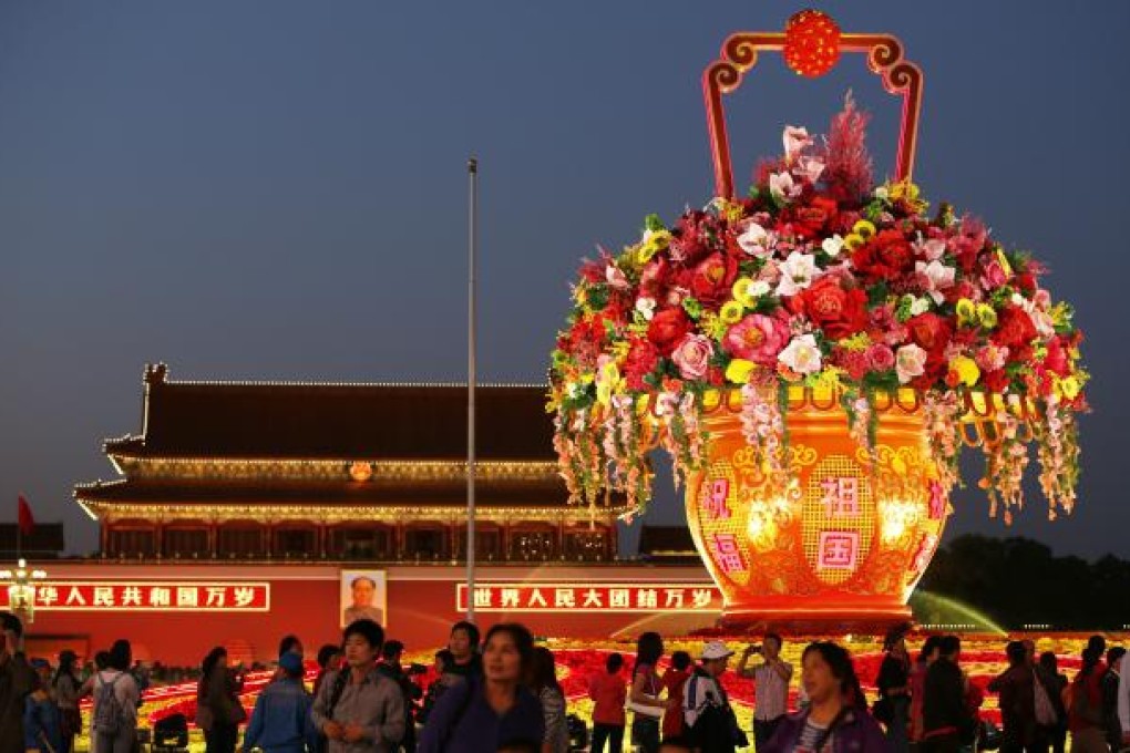 A view of an illuminated giant flower arrangement on Tiananmen Square before the National Day Holidays in Beijing on September 29, 2012. Photo: EPA