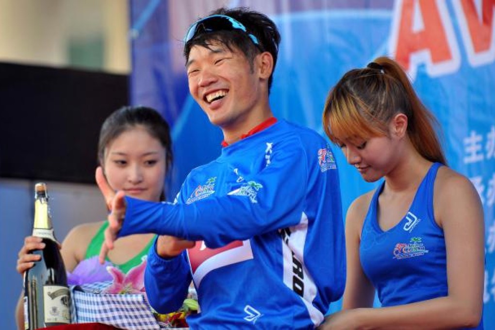Hong Kong's Cheung King Lok puts on the blue jersey after the sixth stage of the 2012 Tour of Hainan International Road Cycling Race.