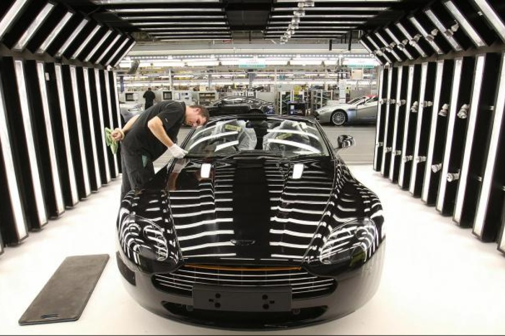 An Aston Martin gets a finishing touch. Beijing Auto is looking to satisfy the luxury lifestyle desire of middle-class motorists. Photo: Bloomberg