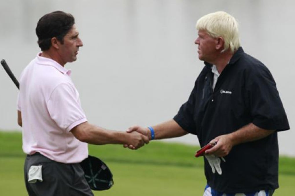 Jose Maria Olazabal, left, shake hands with John Daly on the 18th green during the first round of the Masters Shanghai on Thursday. Photo: AP
