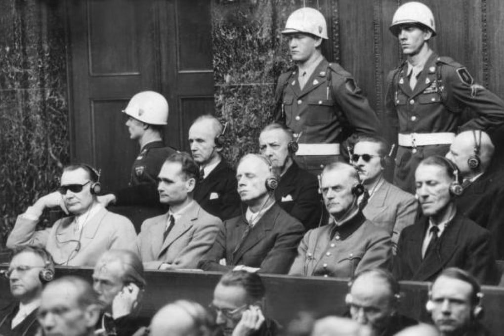 Hermann Göring (left, in dark glasses) sits beside Hermann Hesse and other top Nazis at their trial in Nuremberg. Photo: Keystone