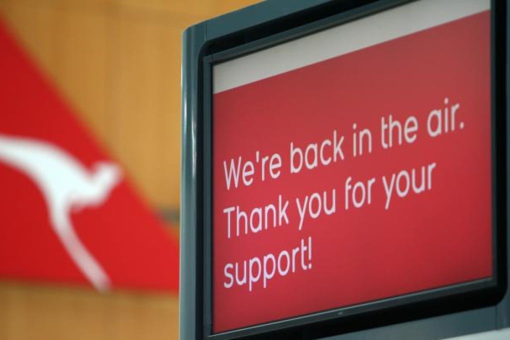 Qantas signage at Sydney International airport on October 31, 2011 signals the end of a 46-hour grounding of the fleet sparked by a bitter industrial row. Qantas chief executive Alan Joyce said he has no regrets about the decision to pull all the airlines planes out of the sky for almost two days. Photo: AFP