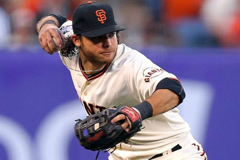 Giant's Brandon Crawford throws to first base against the Detroit Tigers. Photo: AFP