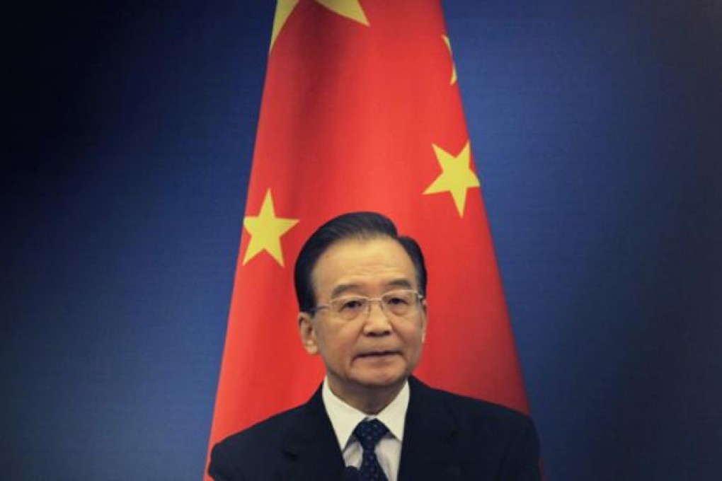 China's Premier Wen Jiabao stands in front of a Chinese national flag as he attends a news conference at the Great Hall of the People in Beijing in May. Photo: Reuters