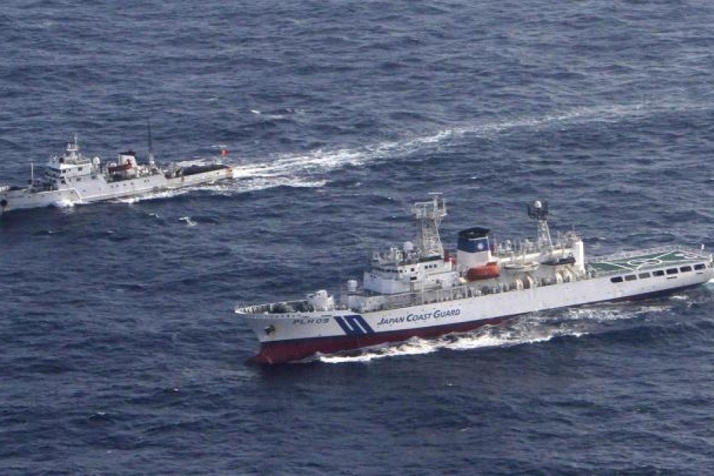 A Japan Coast Guard patrol ship (right) sails around a Chinese patrol ship near the disputed islands in the East China Sea. Photo: Reuters