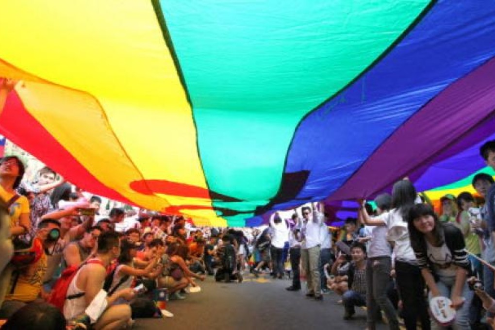 Demonstrators carry a huge rainbow flag as they take part in the 2012 Gay Pride March in Taipei on Saturday. Photo: EPA