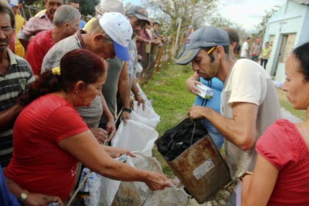 Cubans make line to receive charcoal in Antillas population, Holguin province, 750km east of Havana. Photo: AFP