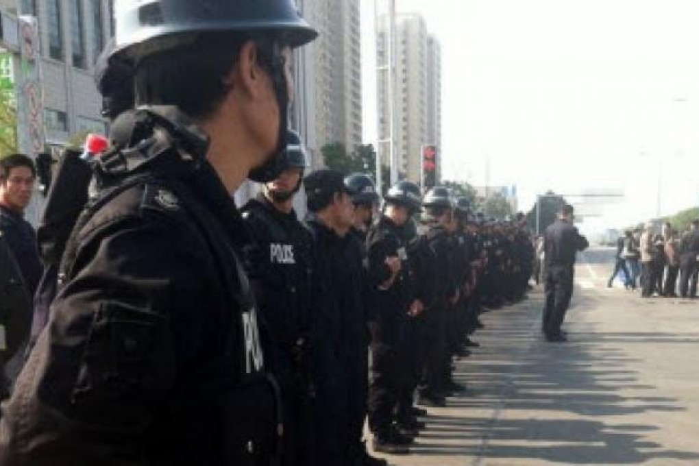 Police line up in Ningbo where thousands gather to protest against a chemical plant. Photo:Handout