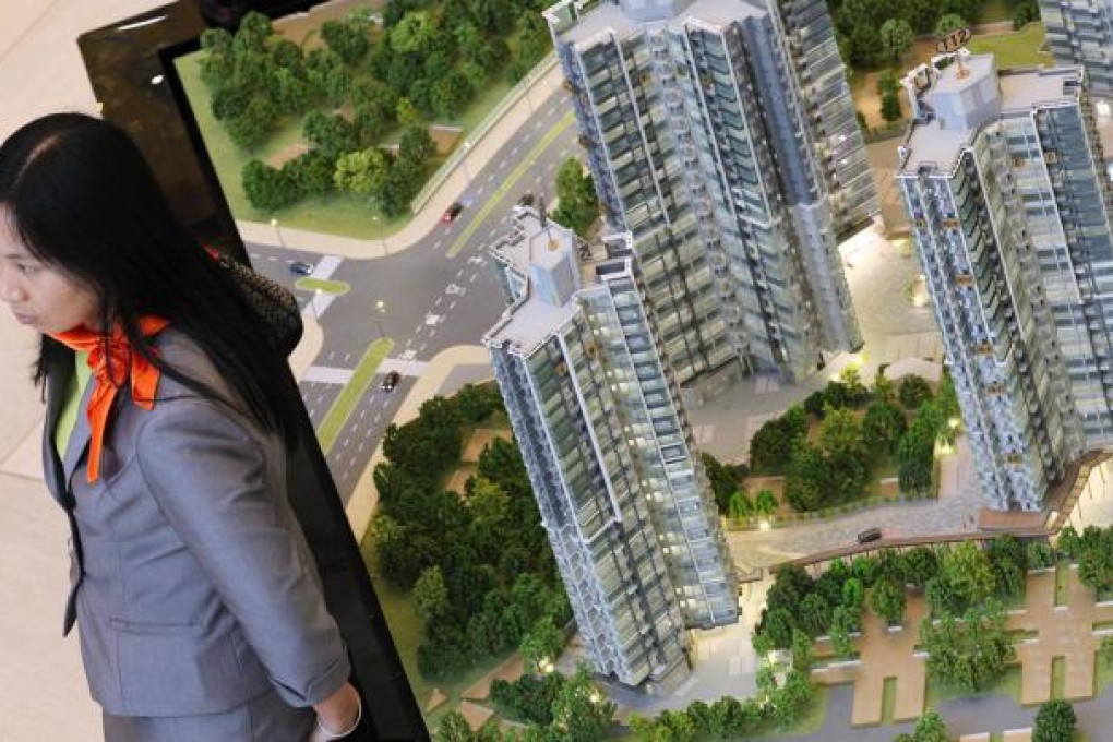 A saleswoman yesterday waits for flat buyers. Photo: Nora Tam