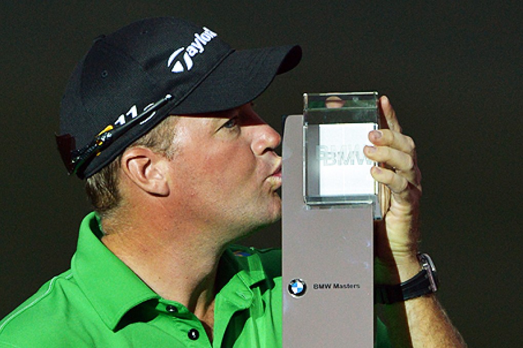 Peter Hanson of Sweden kisses his BMW Masters trophy in Shanghai on Sunday. Photo: AFP