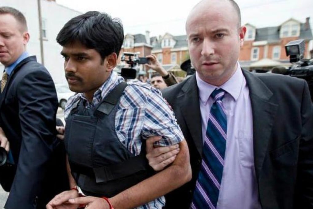 Raghunandan Yandamuri is led into court in a bullet-proof vest.