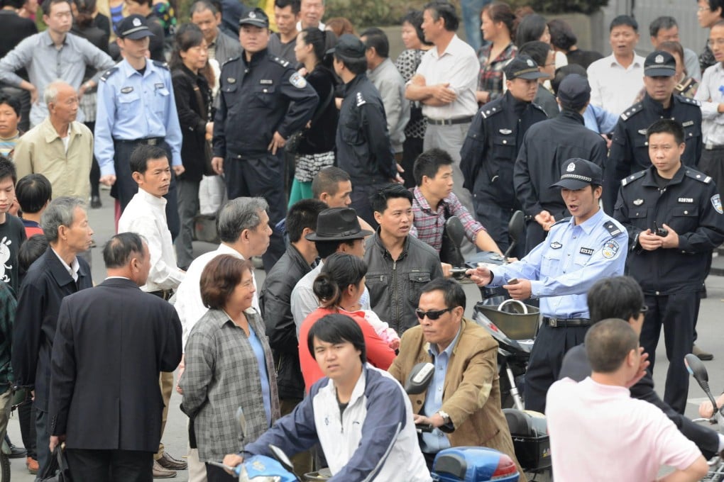 Residents gather outside the Ningbo city government offices yesterday. Officials say the 55.8-billion-yuan expansion has been suspended pending "scientific debate". Photo: AFP