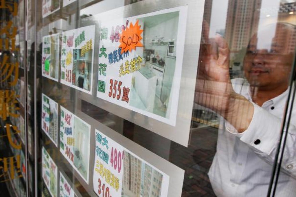 An estate agent posts a sign for a property in Kowloon Bay. Prices in Kowloon East have already risen 15 per cent. Photo: Felix Wong