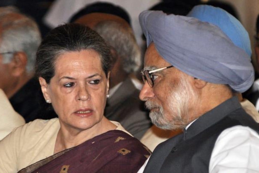 Indian Prime Minister Manmohan Singh (right) and Congress party head Sonia Gandhi speak at the swearing-in ceremony for the new ministers. Photo: EPA