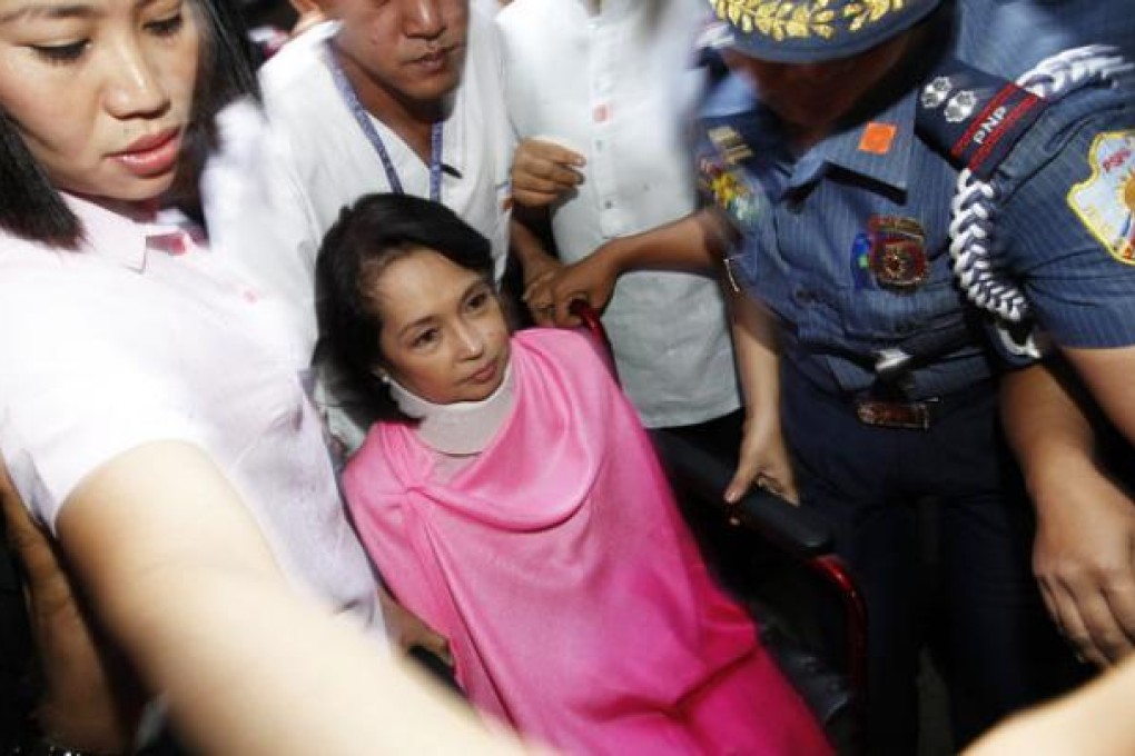 Former Philippine president Gloria Arroyo enters the Sandiganbayan anti-graft court building in a wheelchair, in Quezon City, east of Manila, on Monday. Photo: EPA