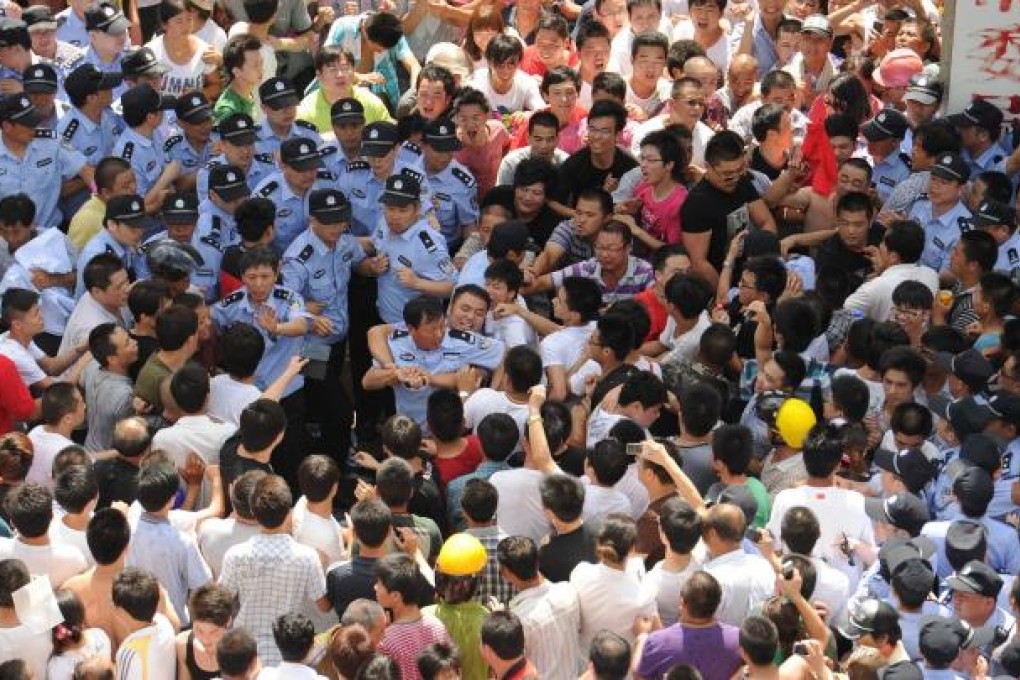 Police and protesters clash in Qidong, Jiangsu, in July over plans for a waste-water pipeline from a paper factory. Photo: AFP