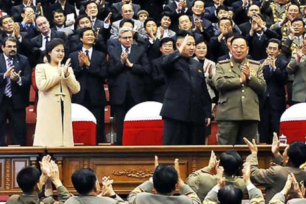 Ri Sol-ju is seen in a beige coat at a musical performance and a football match in Pyongyang on Monday. Photo: AFP