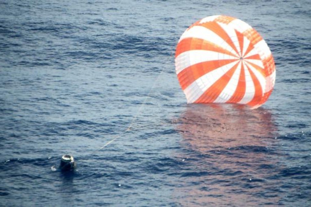 The unmanned Dragon capsule during its splashdown a few hundred kilometres off the Baja California coast. Photo: AP