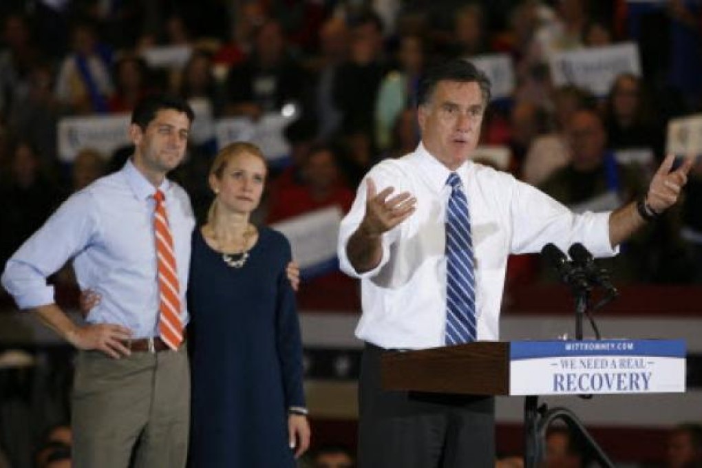 Republican presidential candidate Mitt Romney Paul Ryan and his wife Janna at a campaign rally in Marion, Ohio. The storm on the East Coast caused Romney to join Ryan at the campaign stop in Ohio. Photo: AP