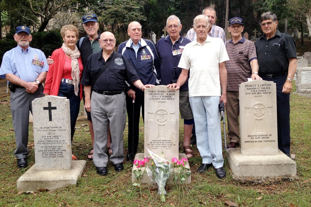 The old sailors from HMAS Voyager and their families pay their respects at the grave of Ernest Howes yesterday. Photo: Christy Choi