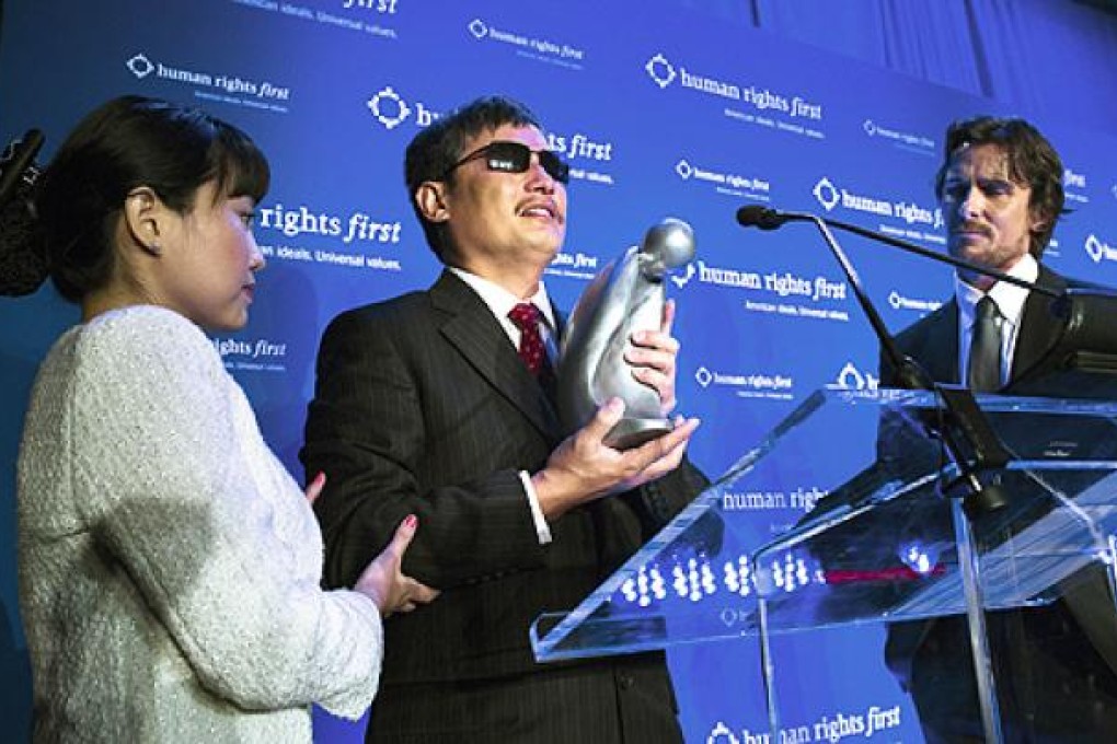 Activist Chen Guangcheng (centre) receives the Human Rights First prize in New York last week. Photo: AP